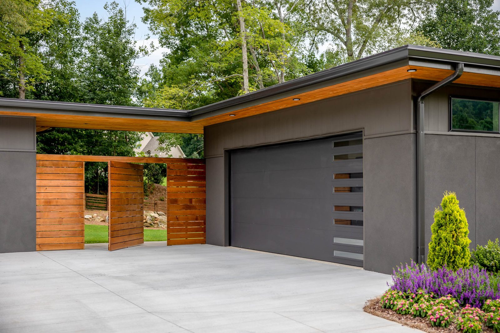 Cedar entry gate beside the garage — The Ortiz Home, custom home built by Ironwood Construction Group in Sugar Hill, Georgia