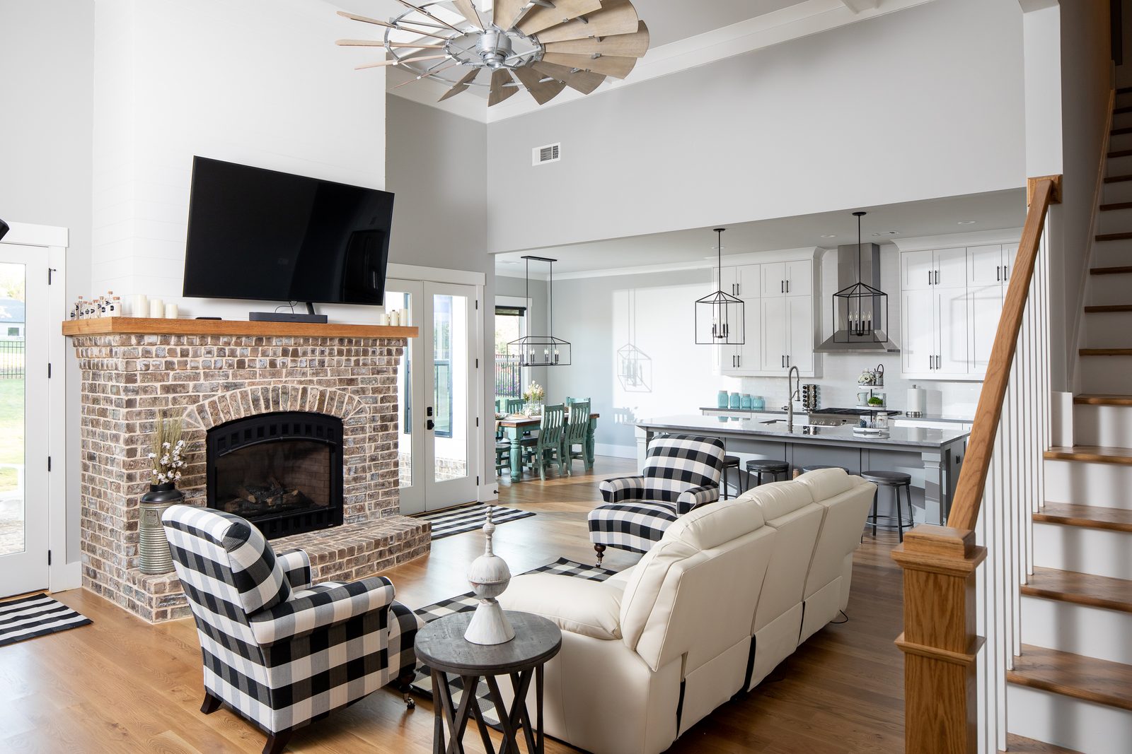 Great room with windmill fan and staircase — Spring 2020 Custom Home, custom home built by Ironwood Construction Group